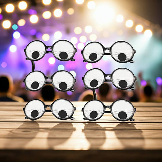 Novelty eyeglasses with googly eyes on a wooden surface with blurred lights in the background
